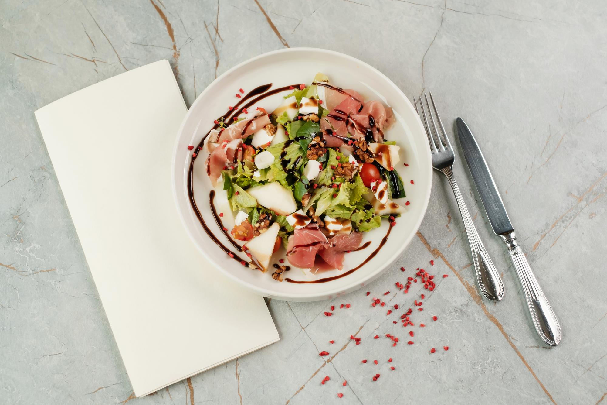 Plated seasonal salad on paper-like placemat